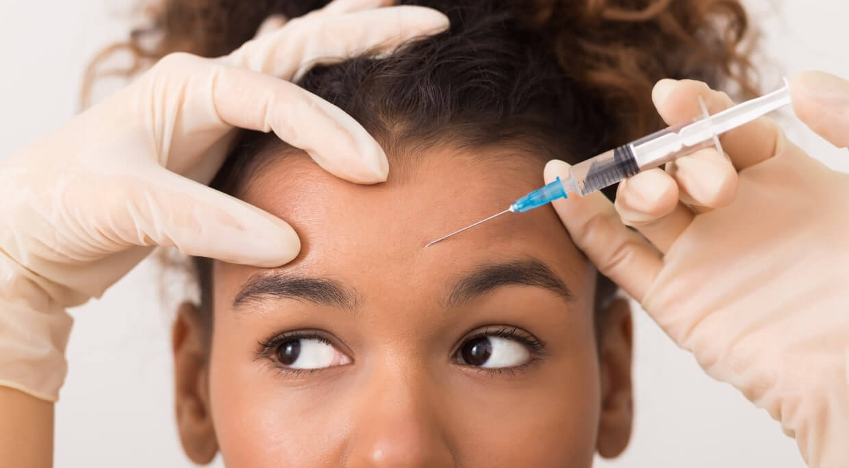 A women receives a botox injection from Aluma Aesthetic medicine in Portland, oregon