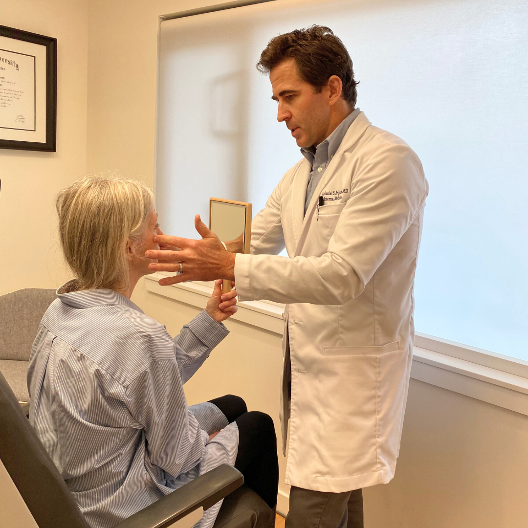 Dr. Brigham talking with patient and evaluating how much sculptra she needs